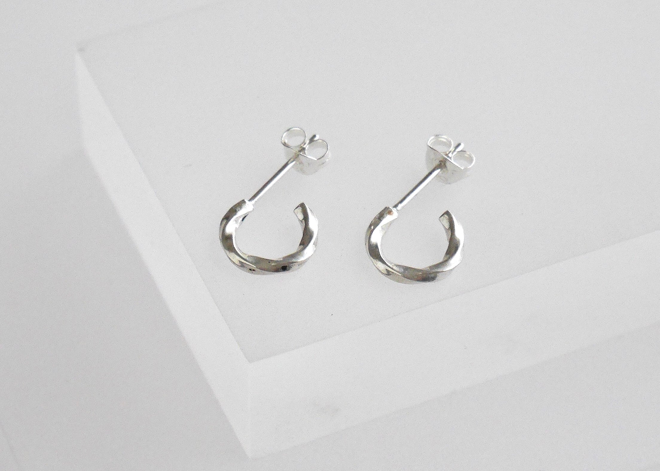 Recycled silver minimal twisted huggie hoop earrings, ethical jewellery handmade in the UK