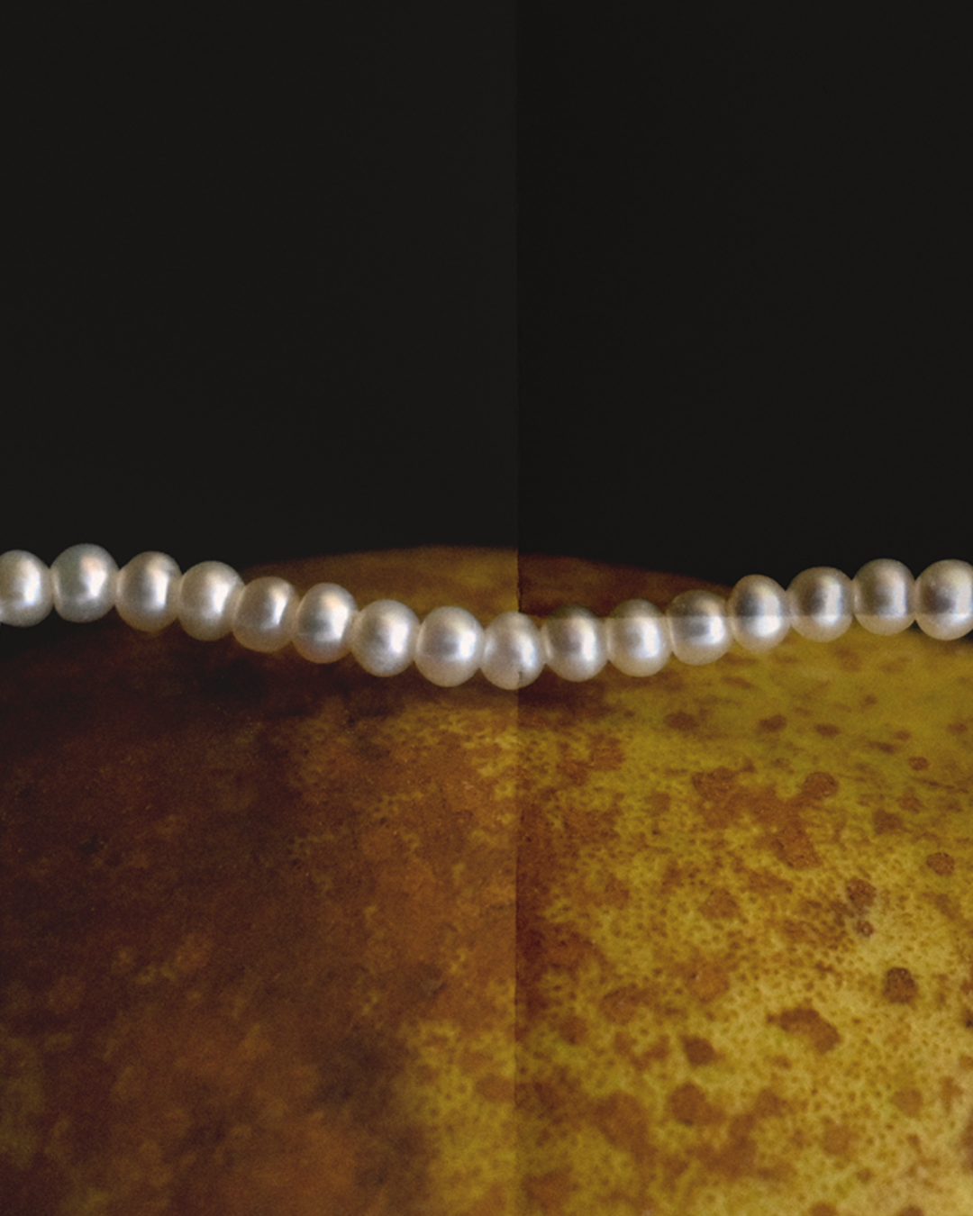 pearl necklace with a pendant on a textured background