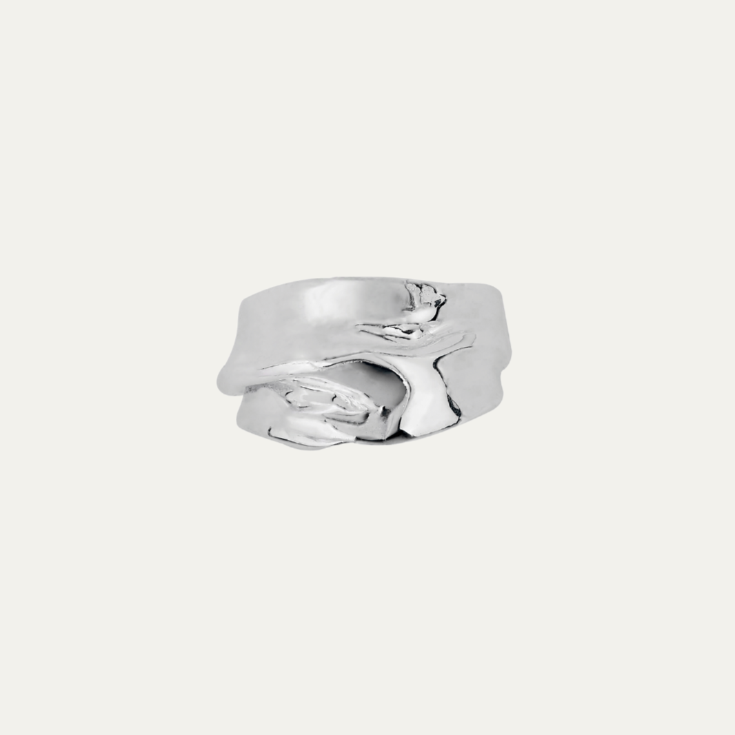 Silver ring with a unique design on a white background
