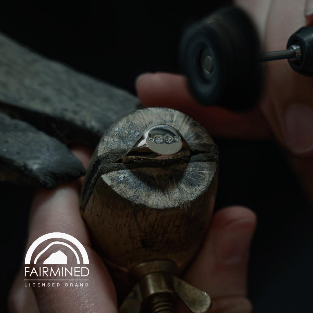Close-up of a Solid Gold Diamond Signet Ring with Fairmined Gold logo.